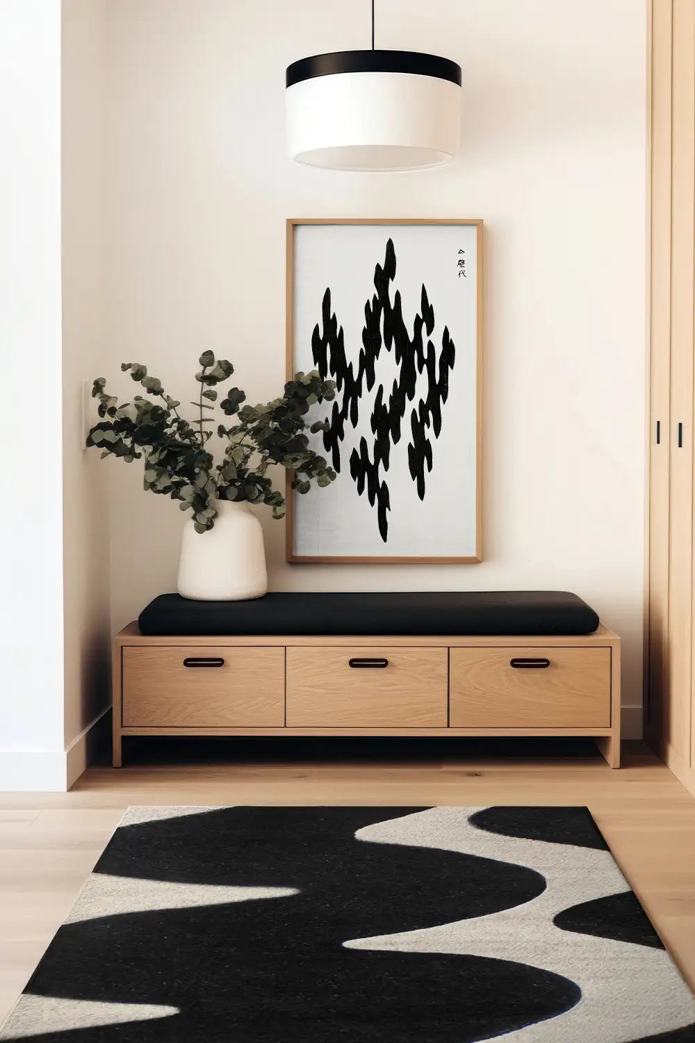 Abstract black and white area rug styled with neutral decor in a modern foyer