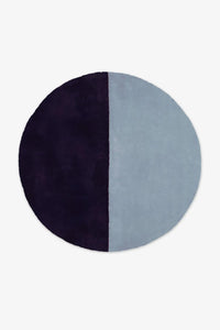 Deep navy and dusty blue wool round rug designed for bold modern living rooms, bedrooms, or coastal homes indigo