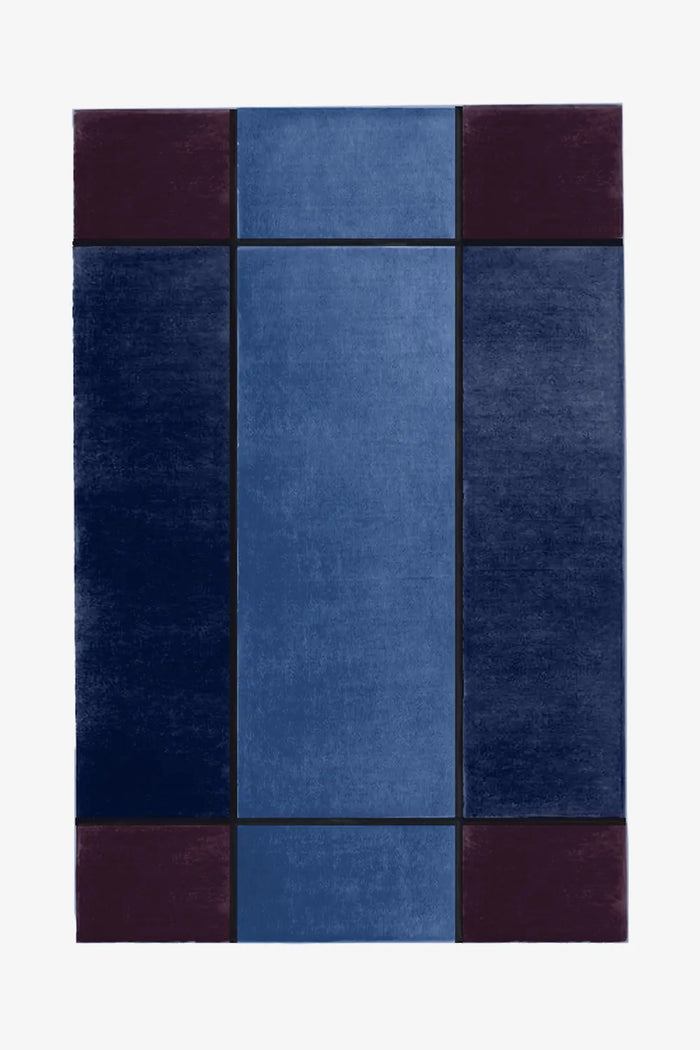 Modern navy blue and plum hand-tufted wool rug with color block design and bold clean edge details
