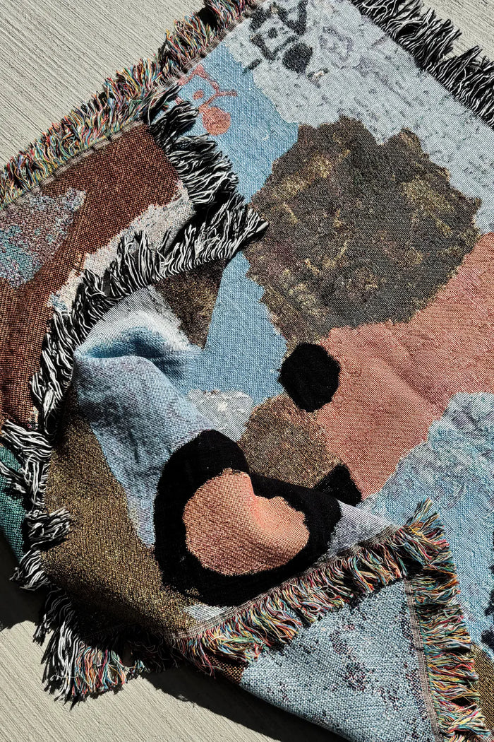 Earth-toned throw blanket with abstract shapes in blues and browns, ideal for layering on beds, sofas, or as a modern accent piece