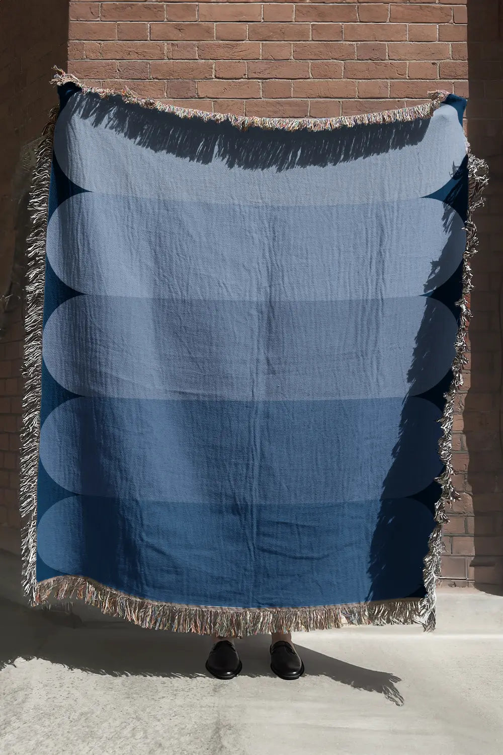 Blue gradient cotton woven throw blanket with soft ombré effect.
