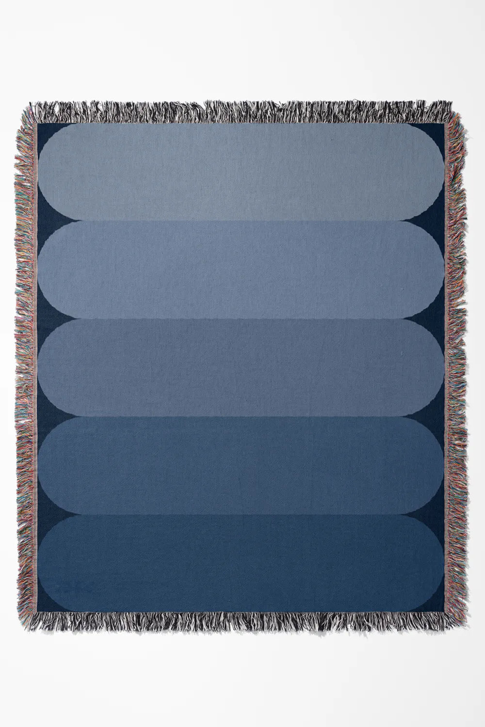 Blue gradient cotton woven throw blanket with soft ombré effect.
