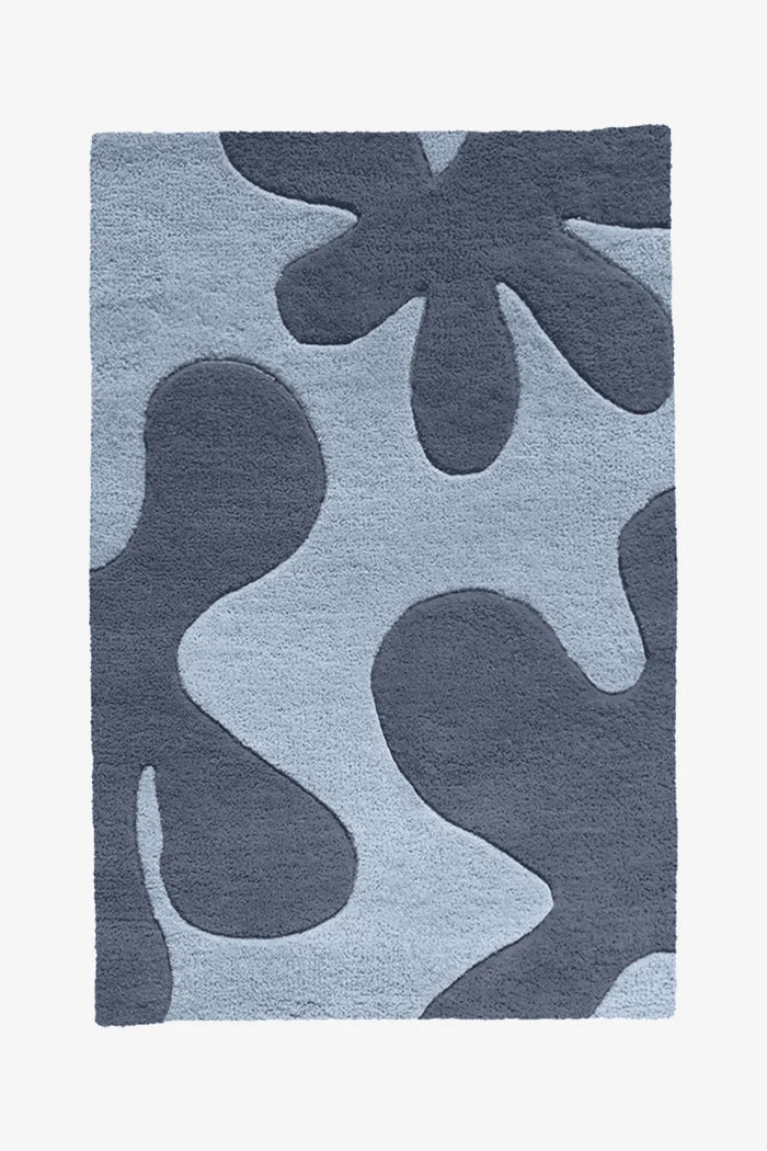 Modern abstract blue wool rug with organic floral shapes and hand-tufted plush texture