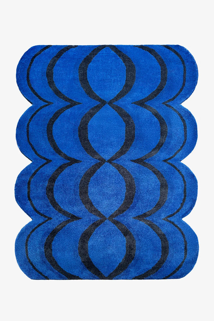 8x10 irregular shaped blue and black wool rug with ripple scalloped edges and funky design