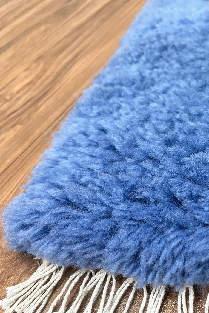 Dark blue shag area rug with deep, rich tones and thick pile.