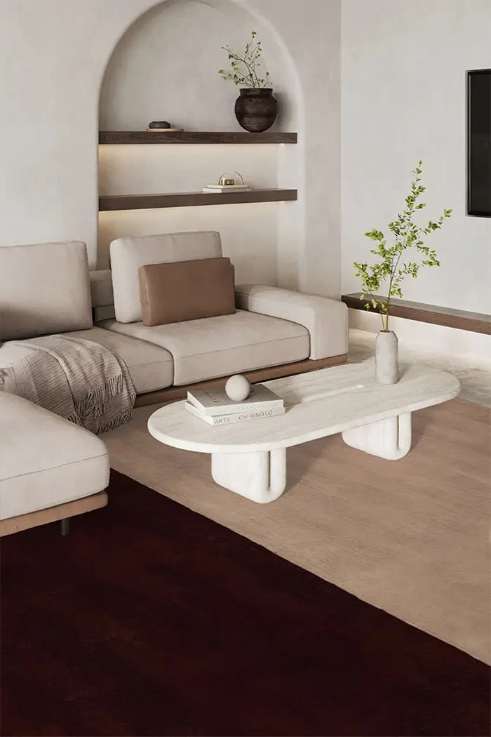 Neutral two-tone wool rug in a modern living room featuring soft textures, a white marble coffee table, and built-in shelving