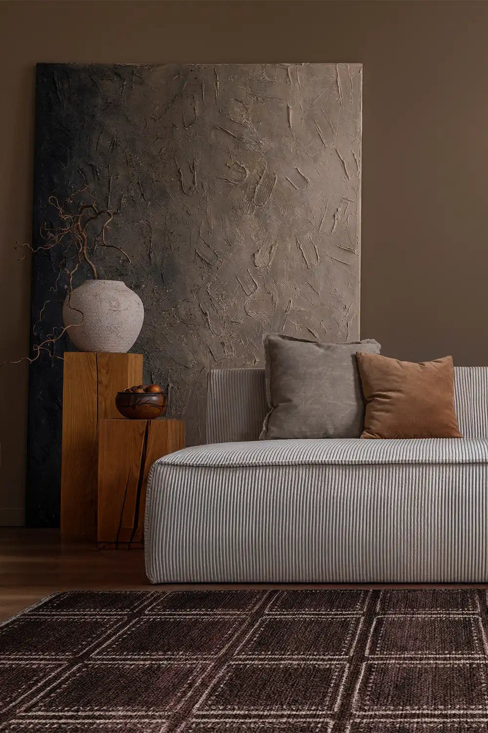 Deep brown handmade wool rug with structured box design in an organic modern living space