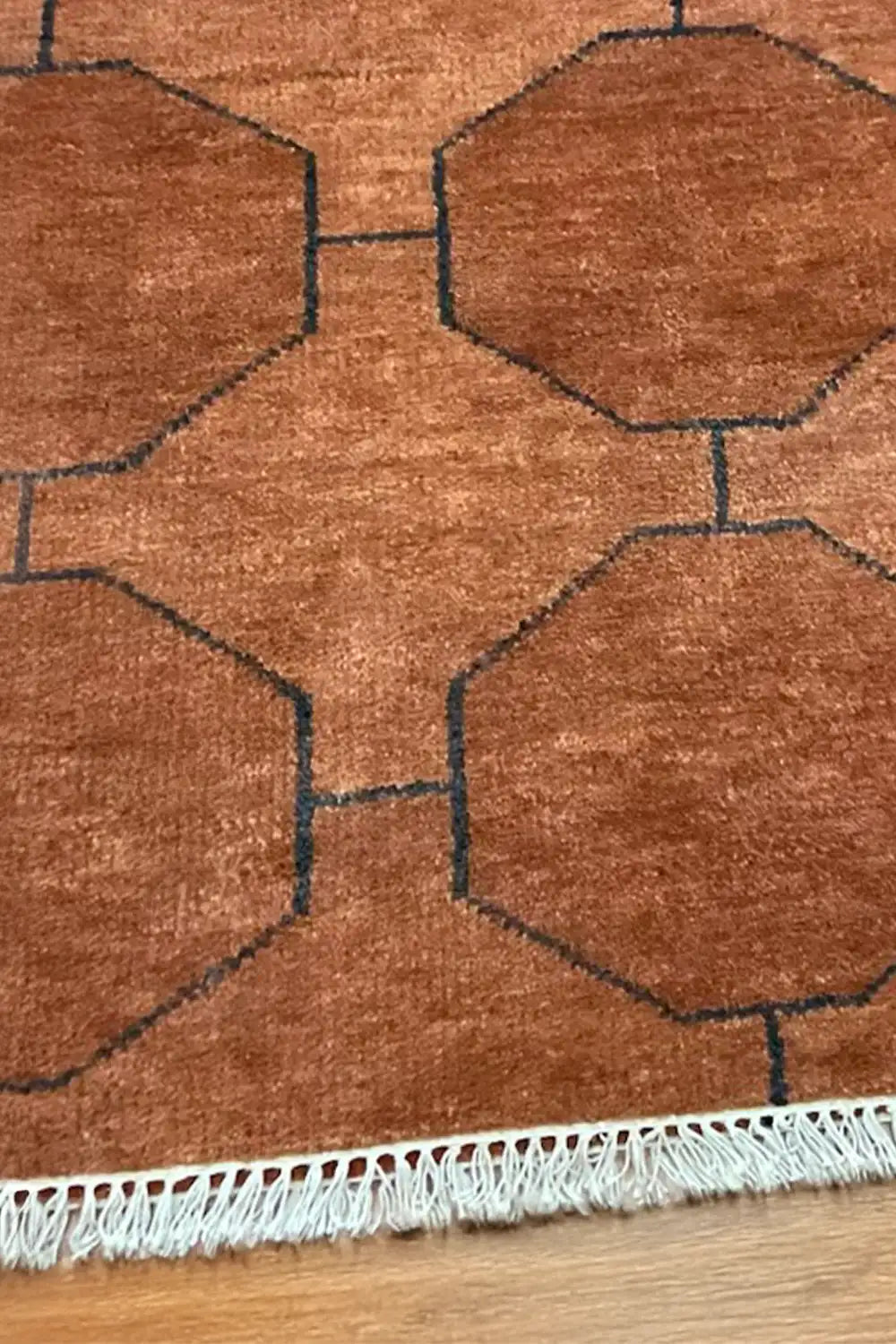 Hand-knotted brown wool runner rug featuring sculpted octagon motif and hand-tied fringe detail
