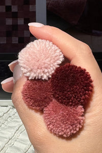 burgundy and mauve wool color poms for a deep plush checkered area rug