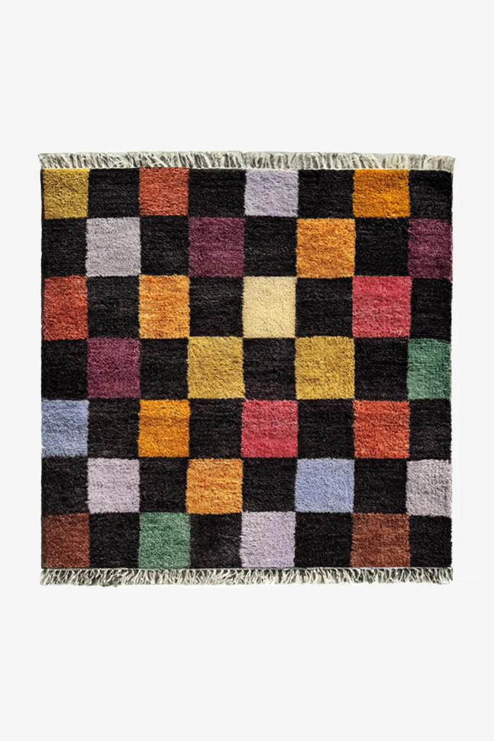 Colorful checkerboard wool rug in square shape, featuring black, yellow, green, and pink blocks, available in 8x8 and custom sizes