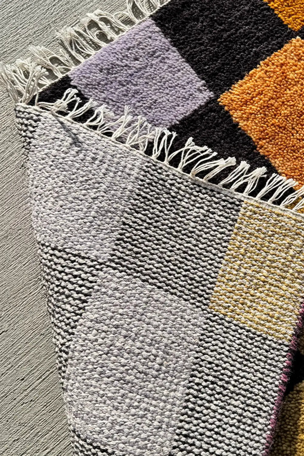 Modern colorful checkered runner rug with mustard, sage, lilac, and burnt orange squares.