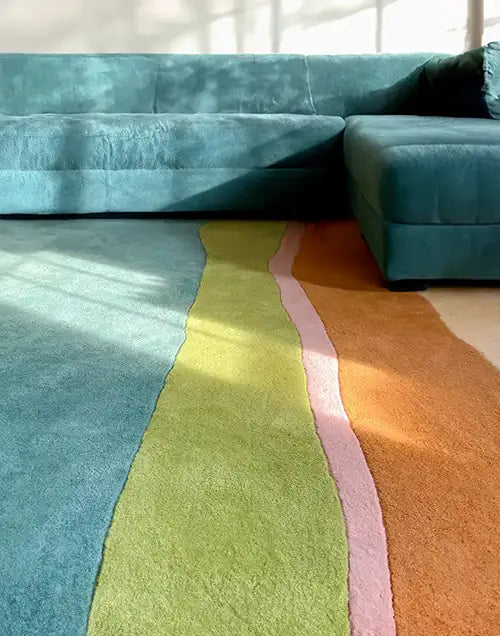 colorful area rug in a modern teal living room setting