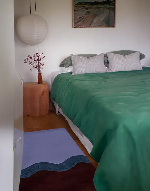 purple and brown wool rug in a modern bedroom 