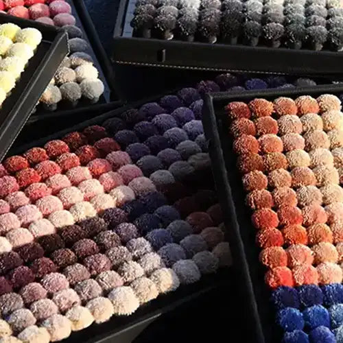 Wool color pom box used for custom made rugs, highlighting the 1,200 color options for boutique rugs and modern wool rugs