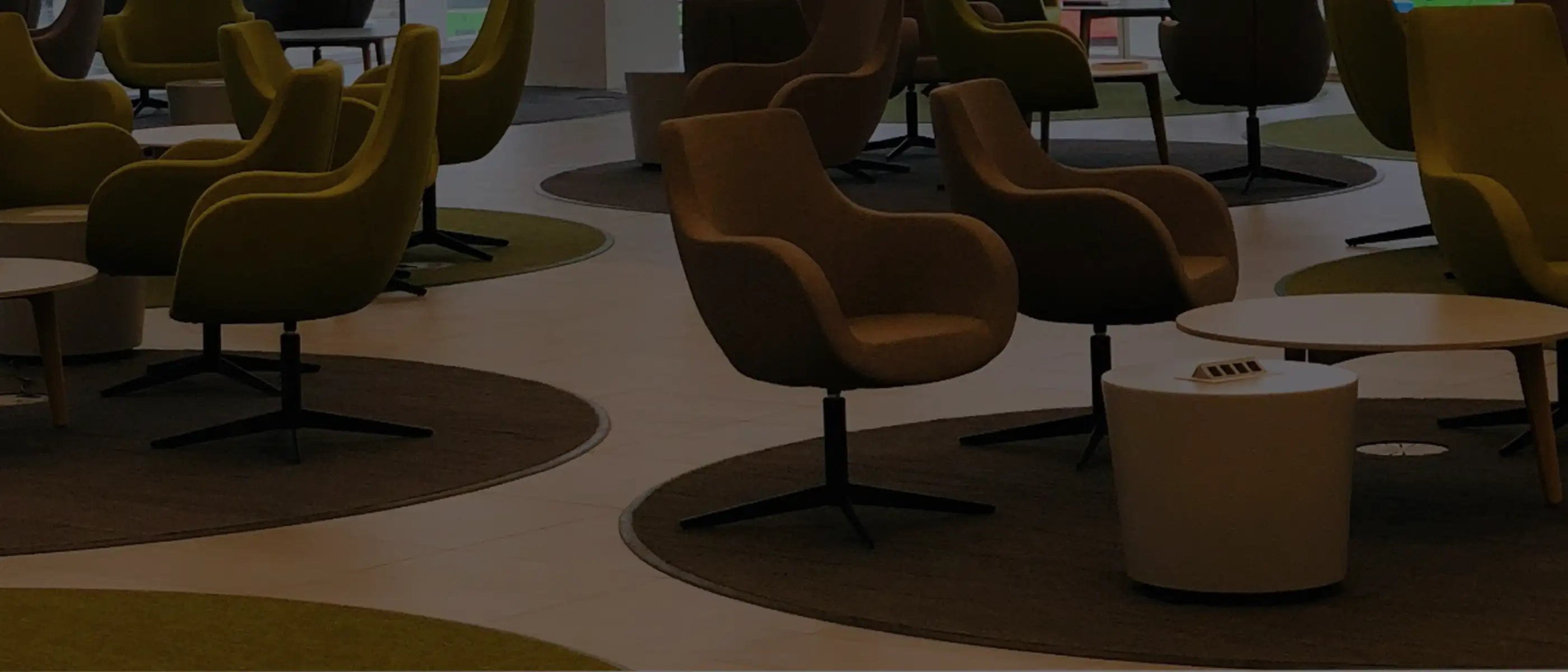 Custom area rugs in a modern office lobby, tailored to fit the space perfectly.