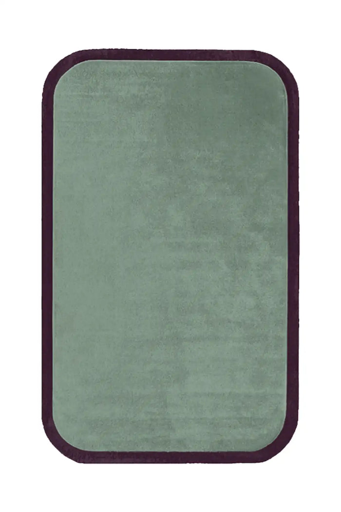 A plush sage green area rug featuring a rounded rectangular shape, accentuated with a dark brown contour edge