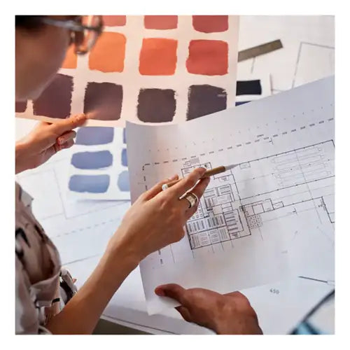 Designer showcasing custom rug sketches and color options to a business client