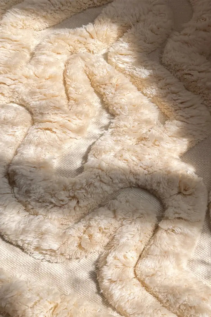Hand-tufted tan cream-colored runner rug with a sculptural, high-pile design featuring organic, wavy textures for a plush and modern aesthetic.