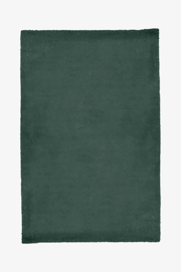 Dark green hand-tufted wool rug in a solid color, ideal as a Japandi or rustic rug for dining rooms