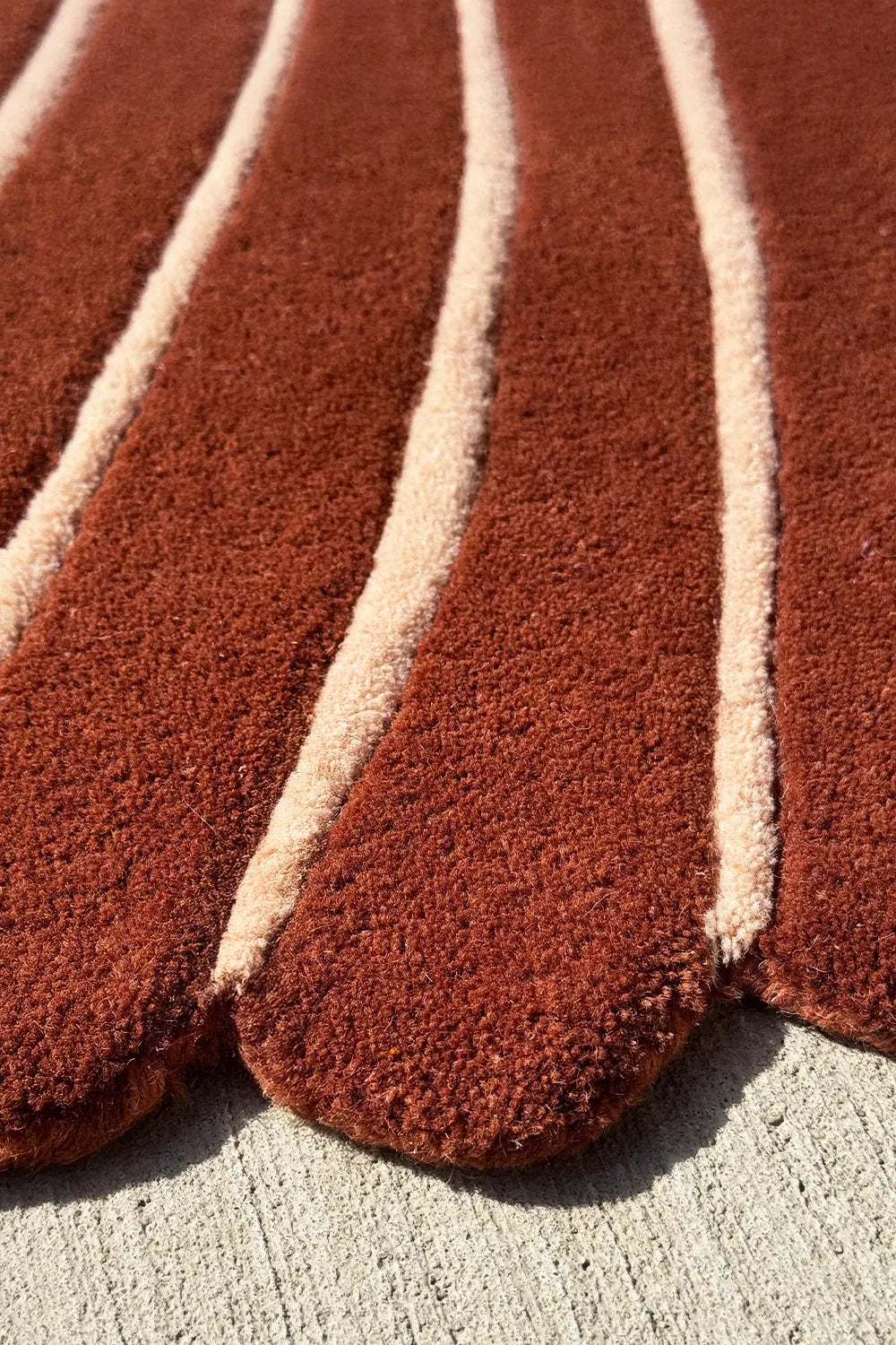 Handmade abstract shape rug in rust and ivory – modern leaf rug for tropical, beachy, or southwestern spaces