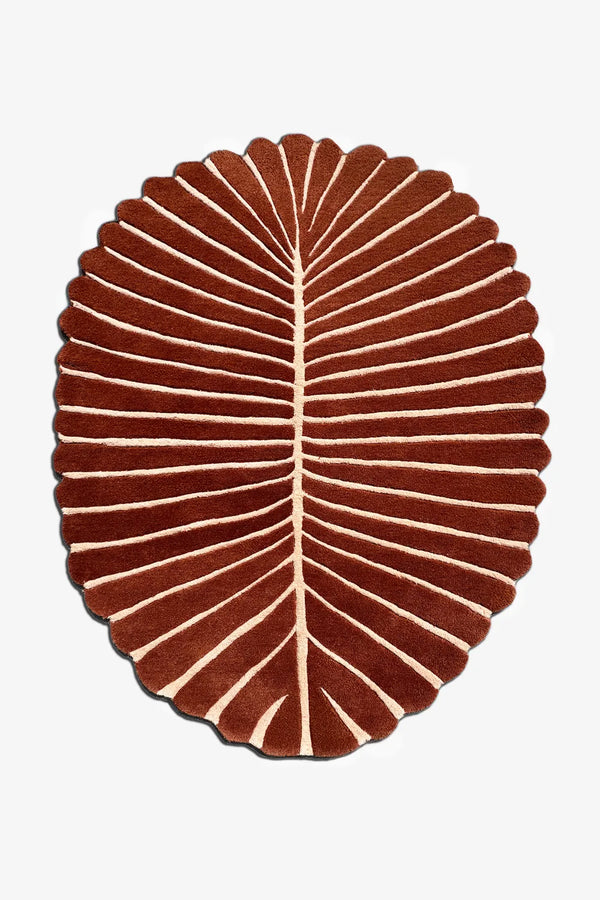 5x8 oval leaf-shaped rug in terracotta and cream with organic scalloped edges for modern boho or coastal interiors