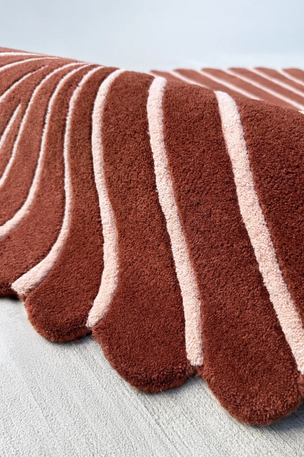Rust and cream scalloped rug with wavy edge – unique organic shaped rug for boho or southwestern living rooms
