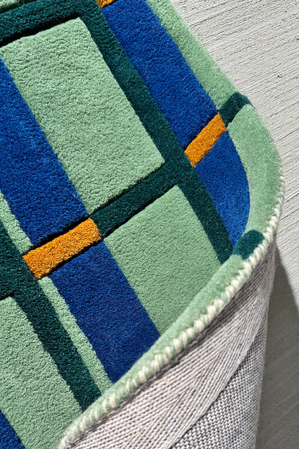 Retro plaid-inspired wool rug with warm and cool tones.
