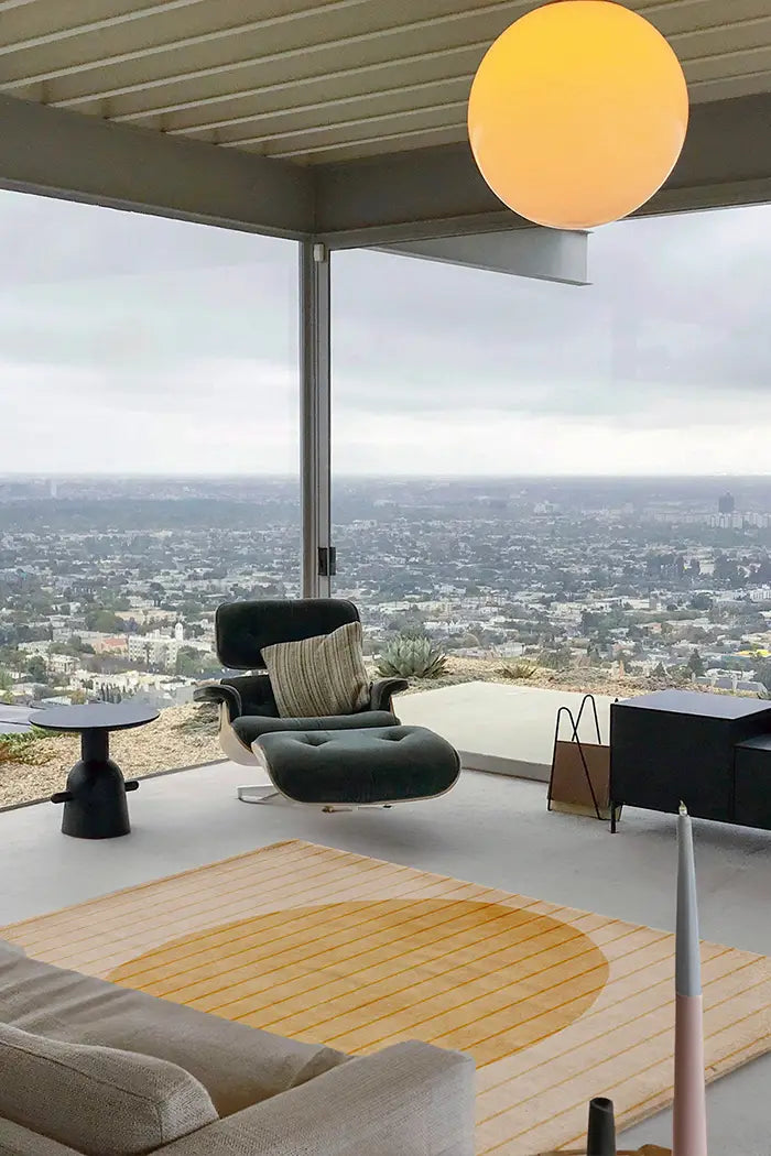 Golden Geometry Tufted Rug styled in a modern open-concept space with a panoramic city view, mid-century seating, and soft neutral tones.
