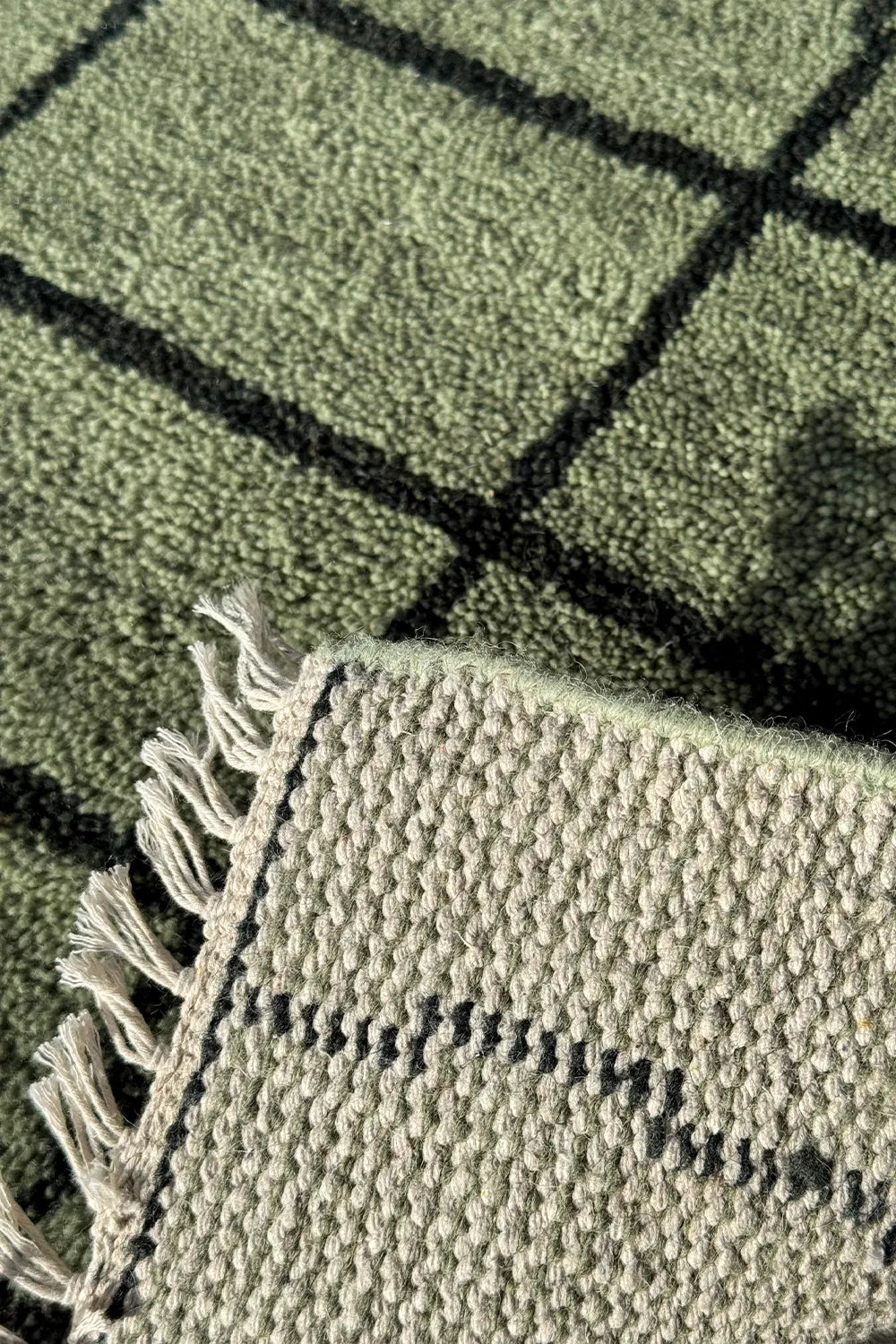 Contemporary hand-knotted wool rug in green and black geometric pattern