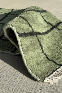Green wool 3x8 runner rug with a geometric grid design, ideal for entryways or kitchens.