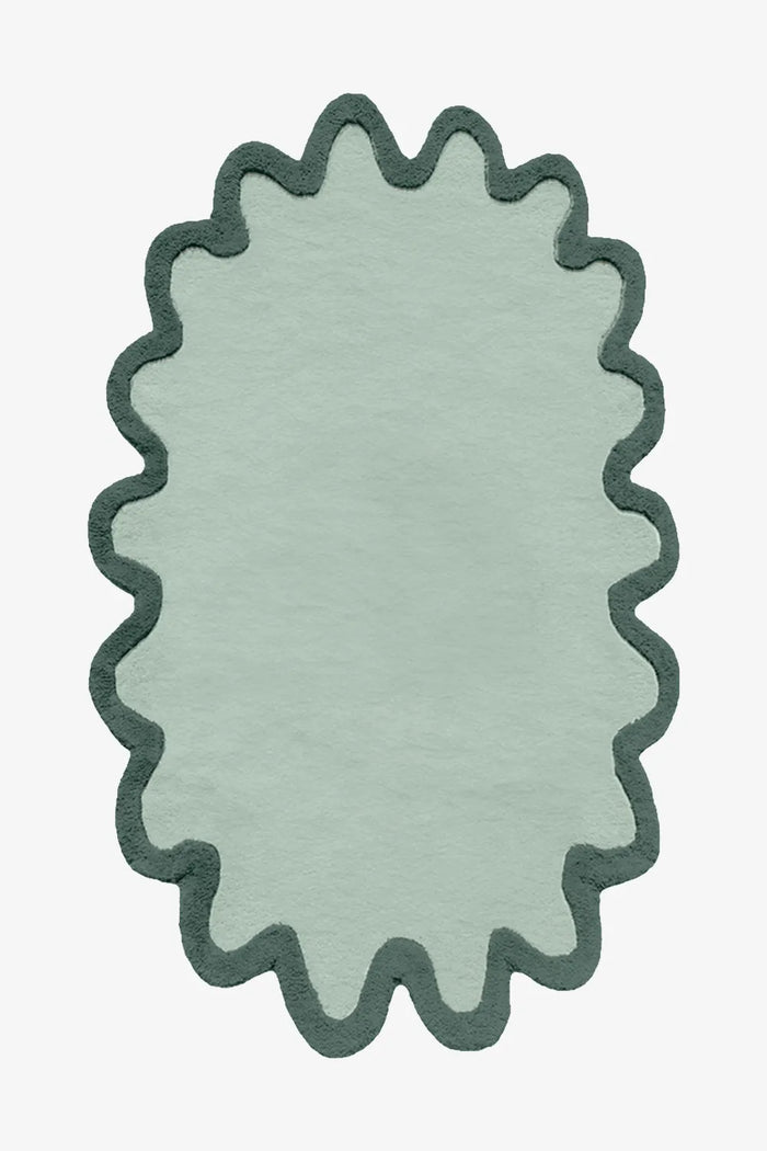 Organic sage forest green scalloped wool rug with dark trim oval shape in 8x10 size