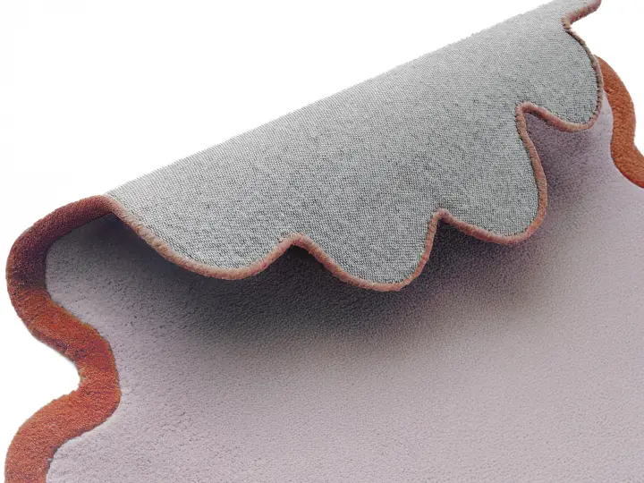Hand-tufted oval rug in rust, perfect for creating a warm and inviting entryway