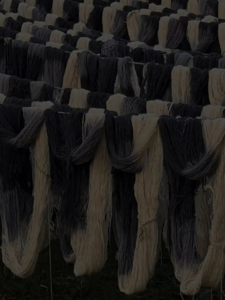 Rows of natural wool yarn hanging to dry, showcasing sustainable and eco-friendly rug materials