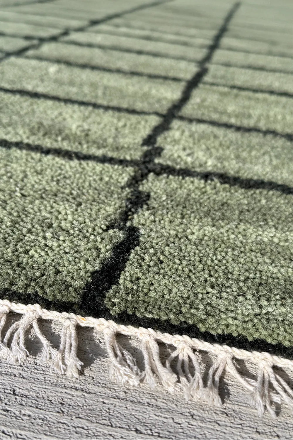 Modern green geometric wool area rug with black grid design for living rooms or bedrooms