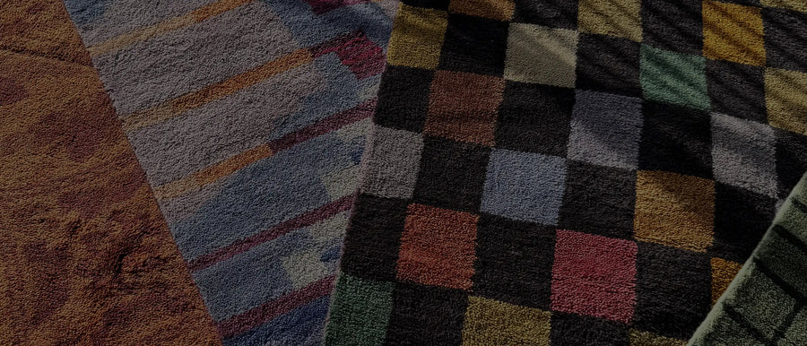 A close-up of colorful textured rugs in various patterns, representing different rug styles and their unique care requirements.