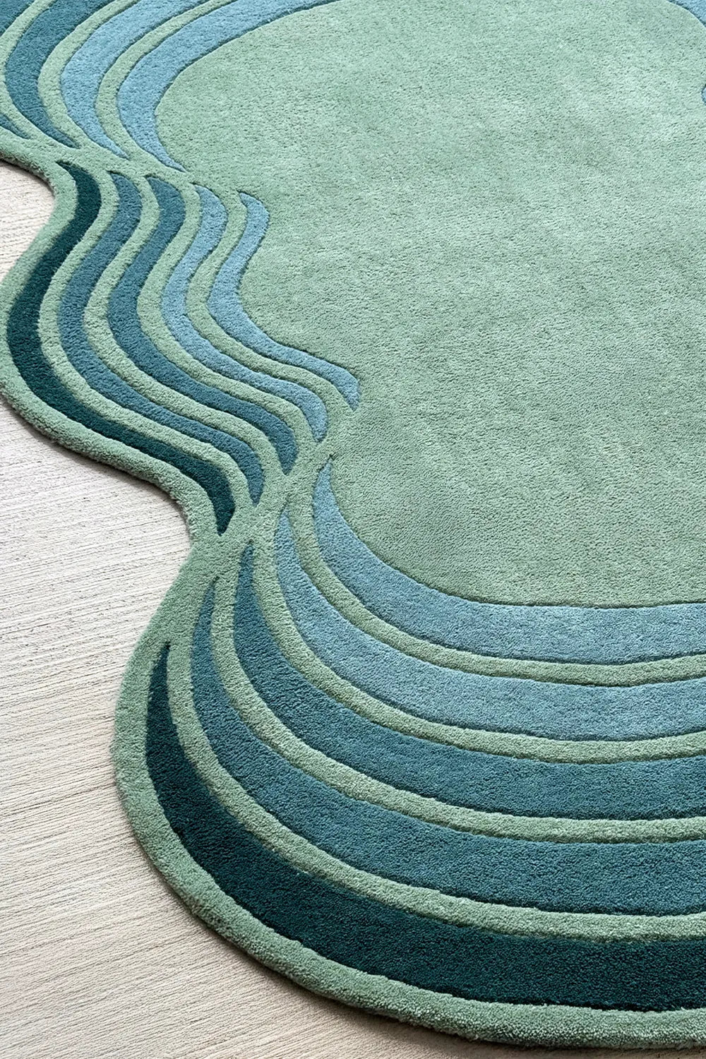Scalloped teal and green rug in an organic silhouette – bold aesthetic rug for contemporary or boho spaces


