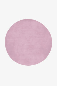 6 ft round pink wool rug in soft lilac tone with plush hand-tufted pile, ideal for bedrooms or nurseries