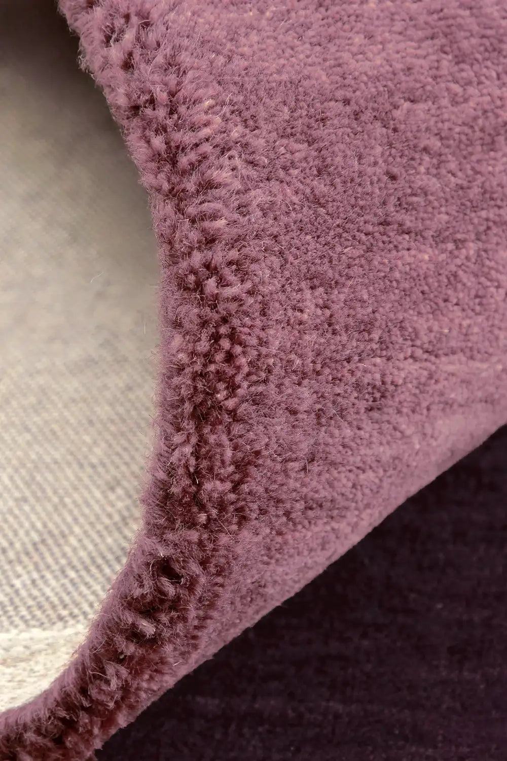 Mauve and burgundy area rug with high pile texture
