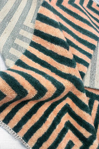multicolor geometric shag wool rug with plush fluffy pile in green and tan