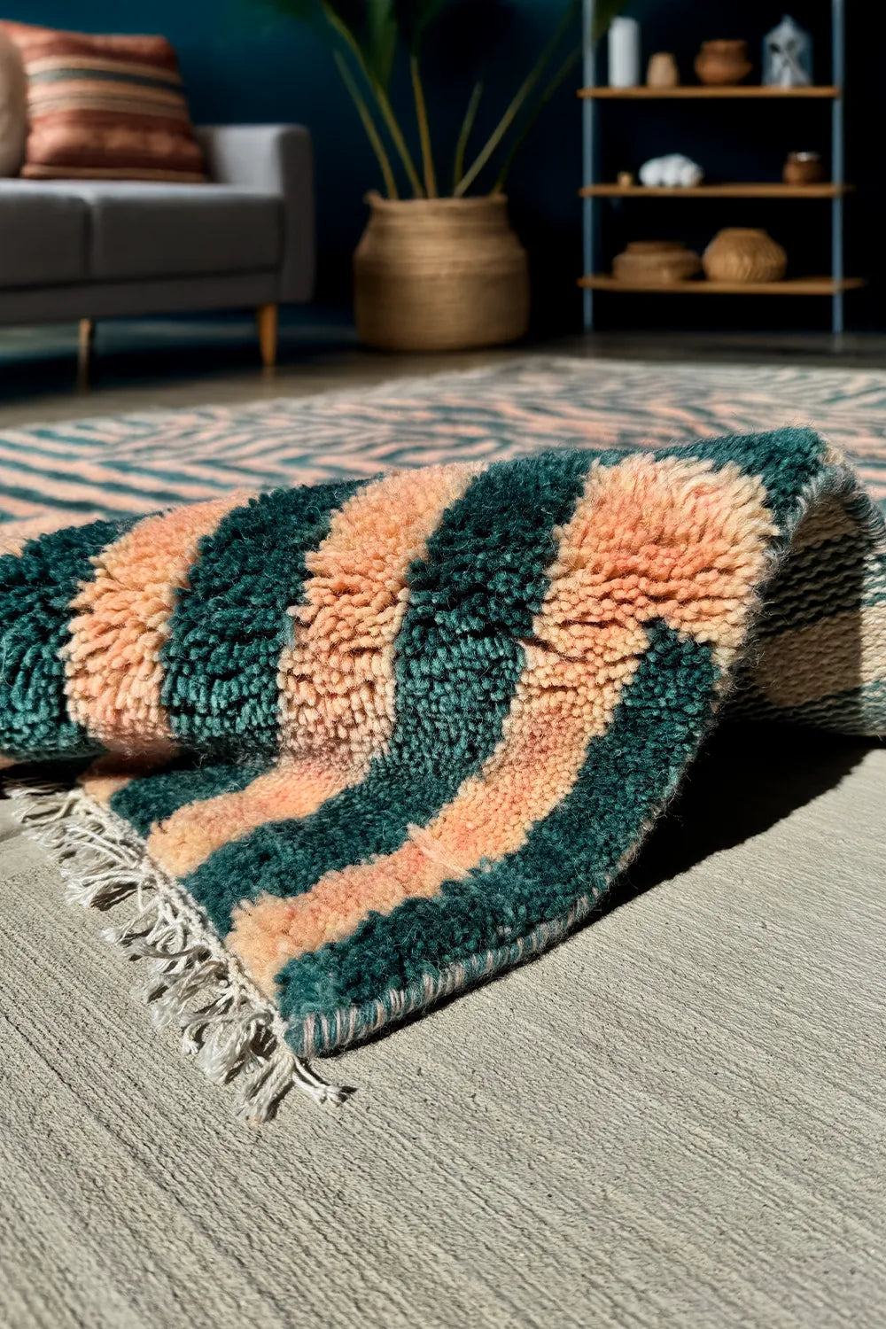 Bold green and peach 5x8 wool shag rug with graphic striped pattern, in a modern living room lifestyle