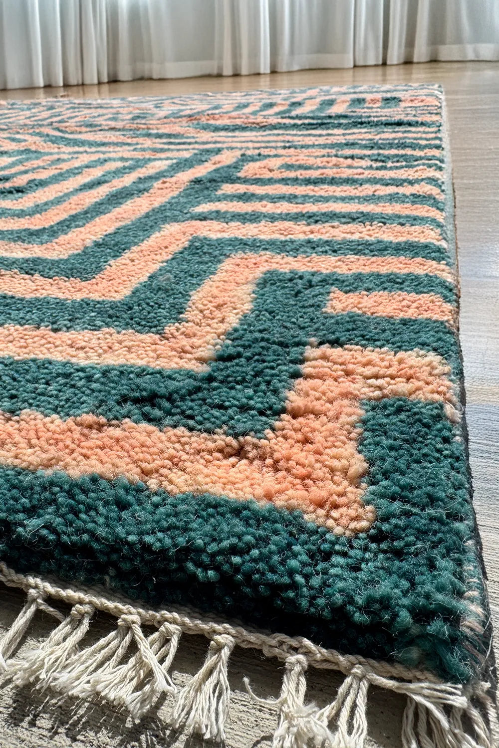 Large area modern shag rug in peach and dark green stripes with bold graphic handwoven design