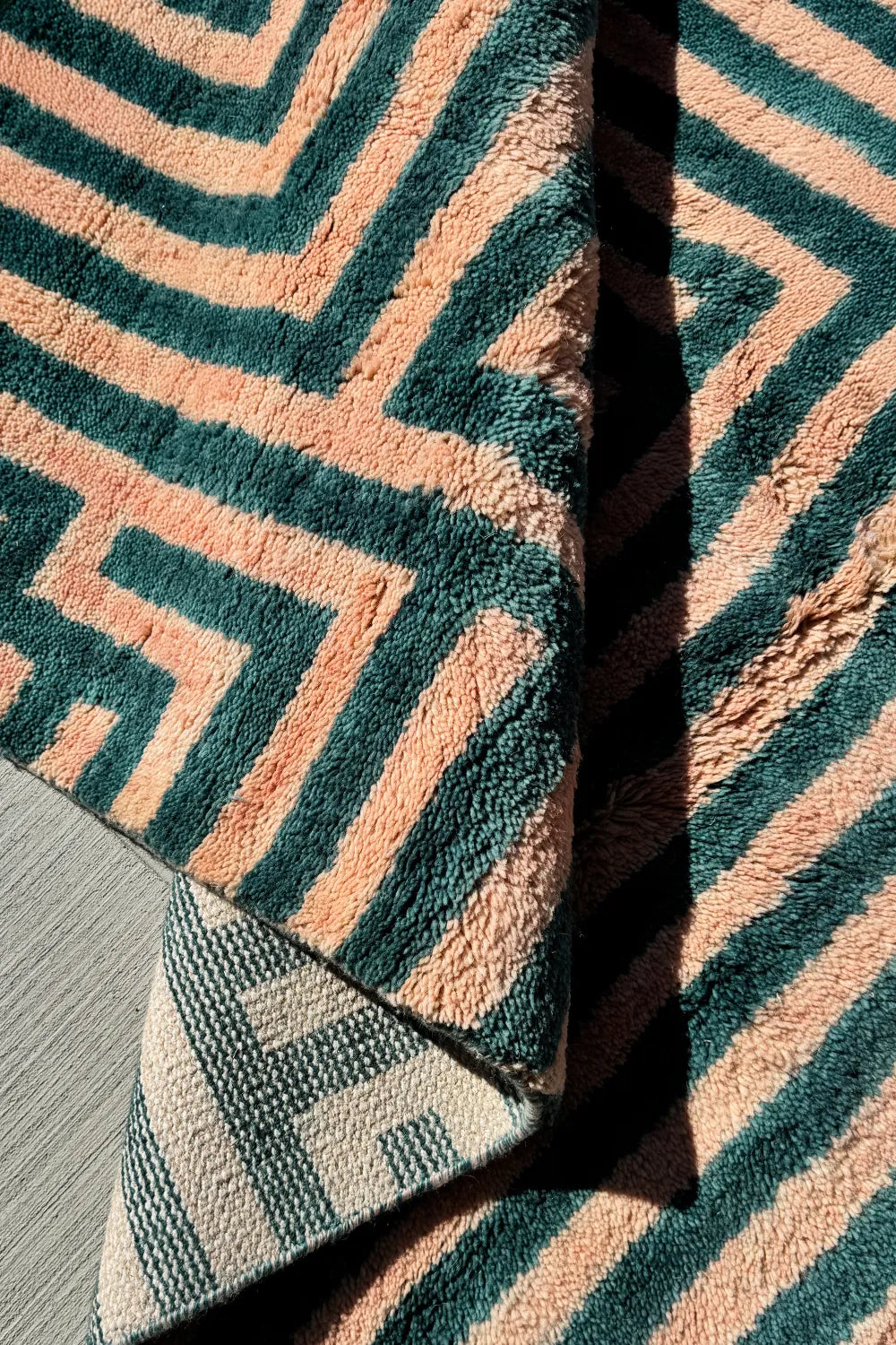 Detail of plush wool pile with rich deep green and pink stripes, ideal for custom colorful rugs and thick tufted wool designs