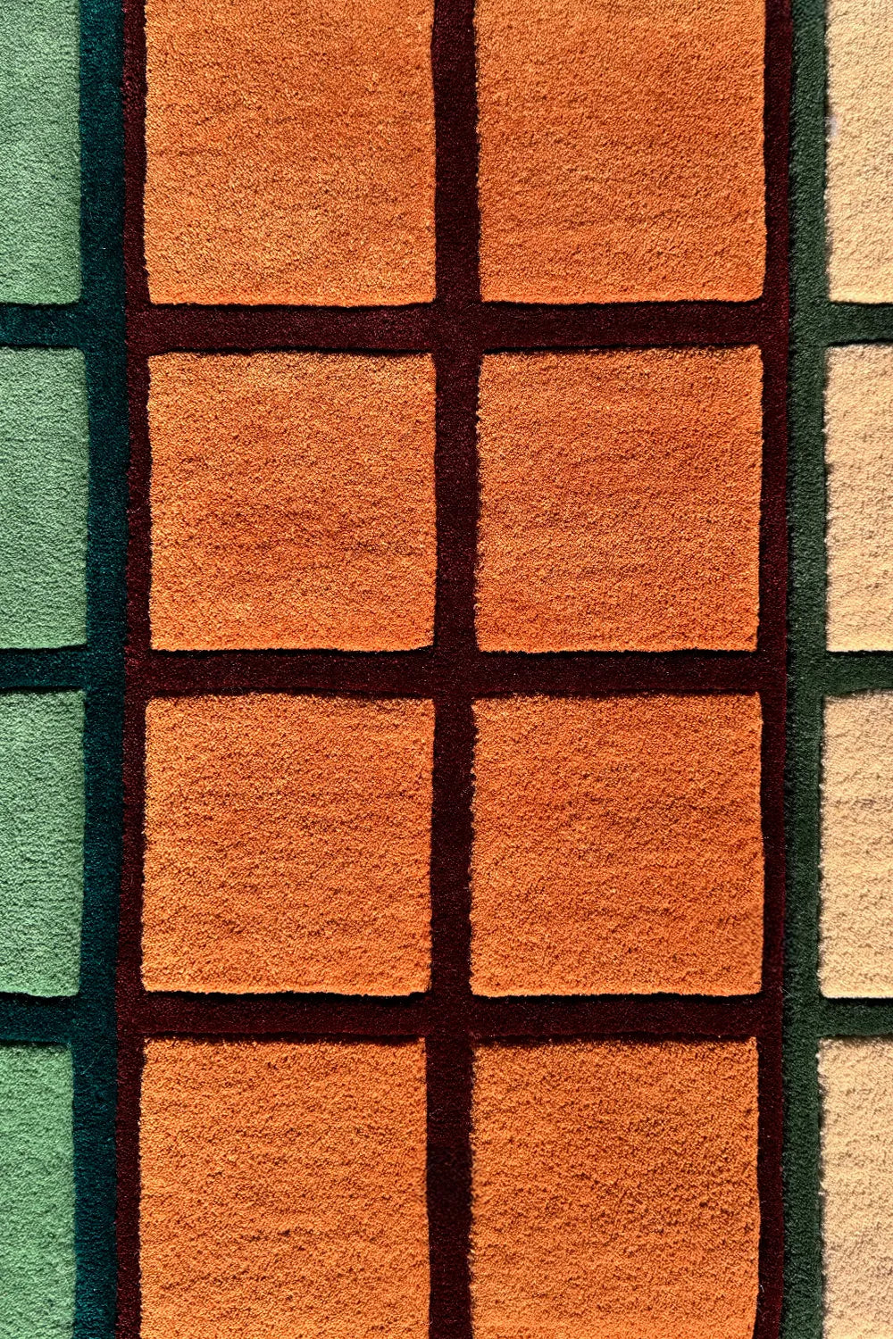 Checkered wool area rug with a unique square block design.