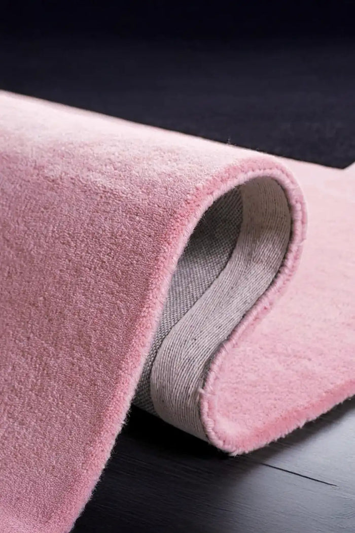 Close-up of plush wool pile and soft pink surface on colorblock 5x8 modern rug