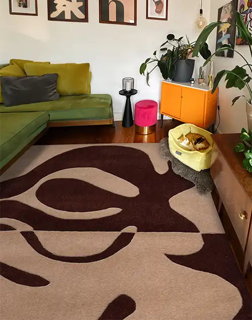 A modern living room featuring a Jubi rug, styled with minimalist furniture and warm, inviting decor