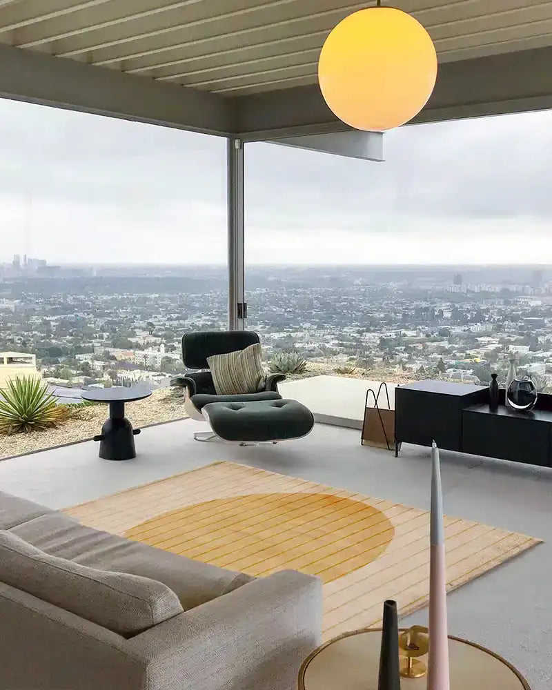 Modern living room with a Jubi rug as the centerpiece, styled with warm, inviting decor