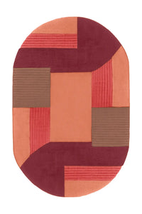 A modern area rug with an abstract geometric design in warm shades of terracotta, blush, and beige, creating a contemporary patchwork effect