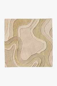 Modern sculpted wool rug in cream and beige tones with organic carved waves, available in 6x6 and 8x8 sizes