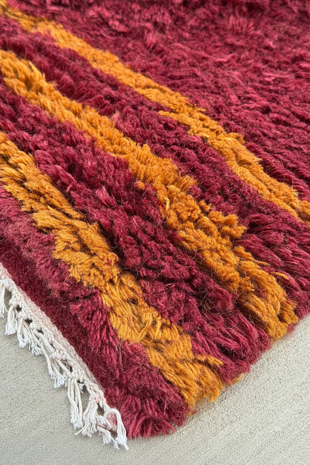 Deep red shag area rug with gold and maroon woven stripe – bold boho rug for eclectic or southwestern decor