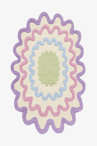 Colorful scalloped oval wool rug in pastel purple, green, and blue, modern boho area rug for playful living rooms and kids' rooms